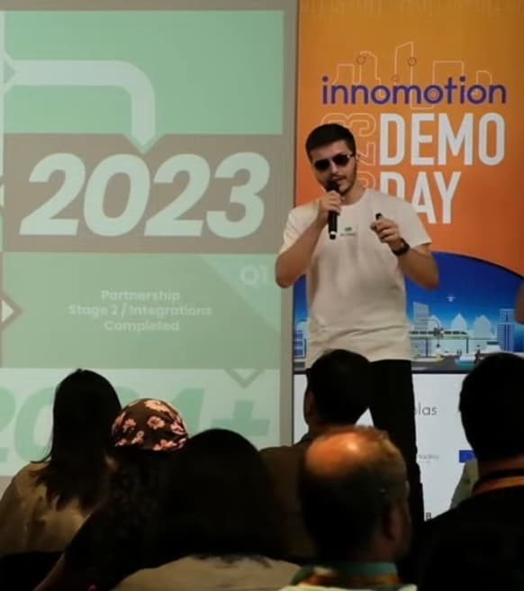Burak Karataş speaking on stage